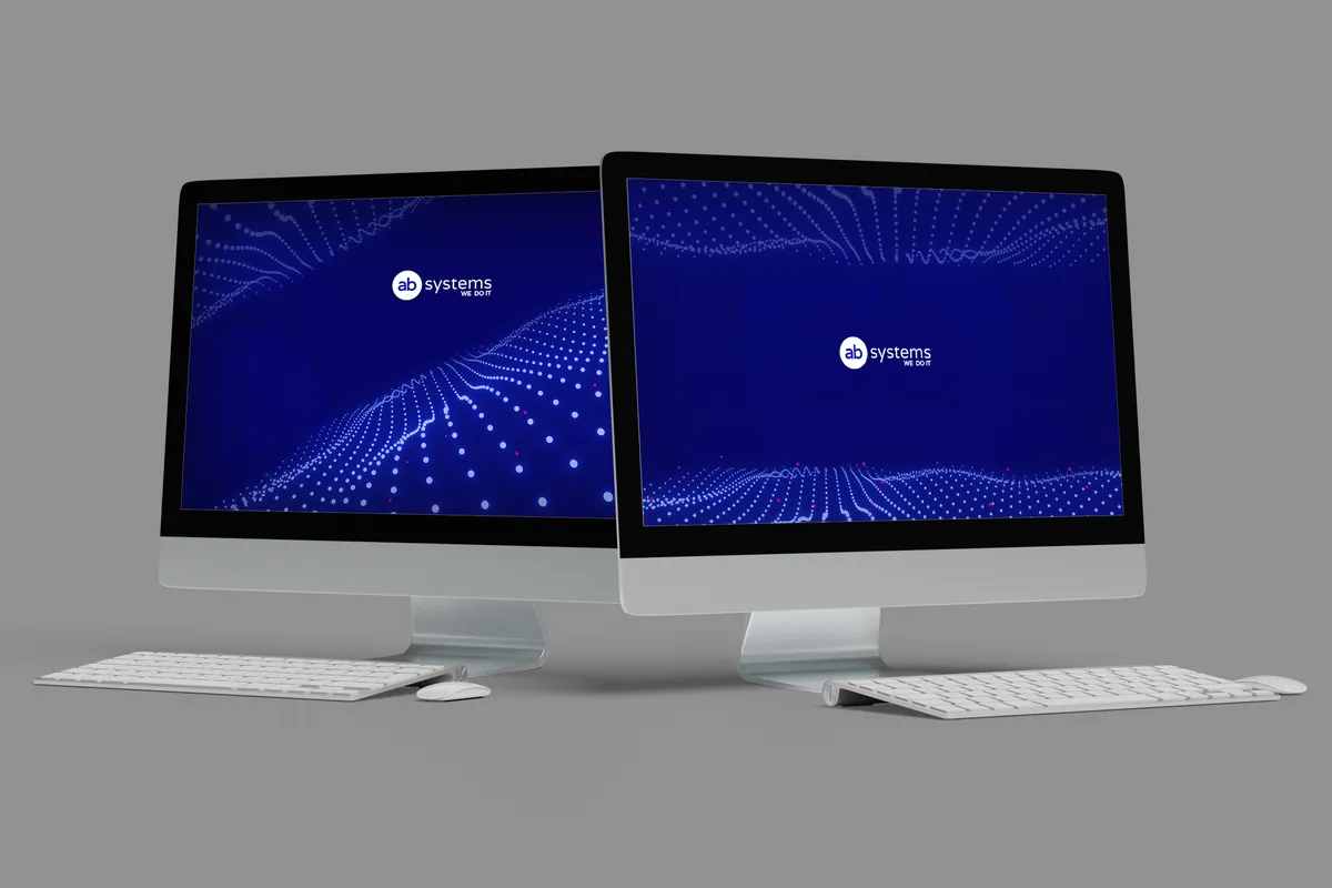 AB Systems: two monitors with navy backgrounds with a wave of points and the logo on a gray background