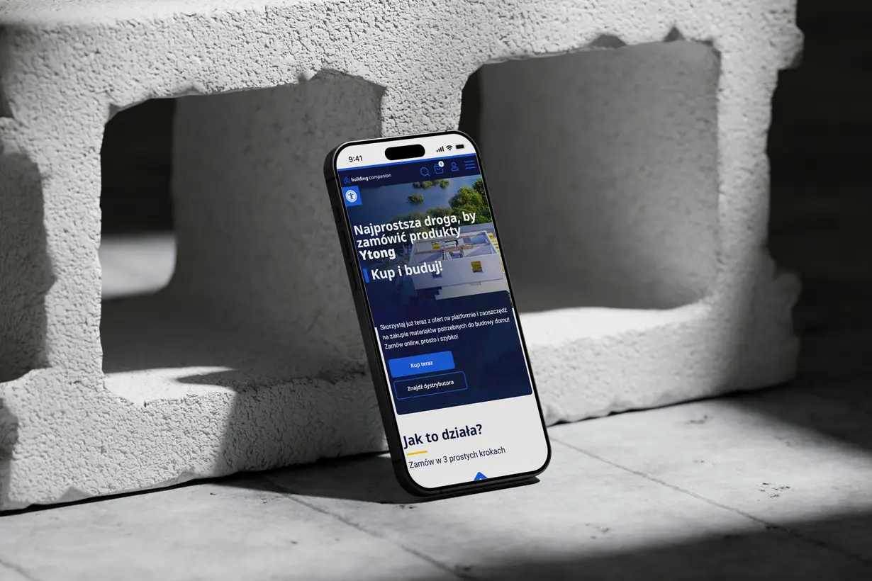 Building Companion: sklep na telefonie opartym o betonowy pustak, hasło o zamawianiu produktów Ytong
