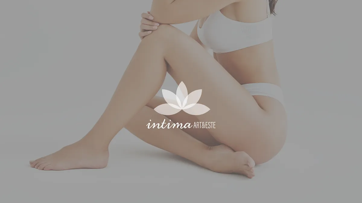 Intima Art&Este: white logo with a lotus on a muted gray photo of a seated woman in white underwear
