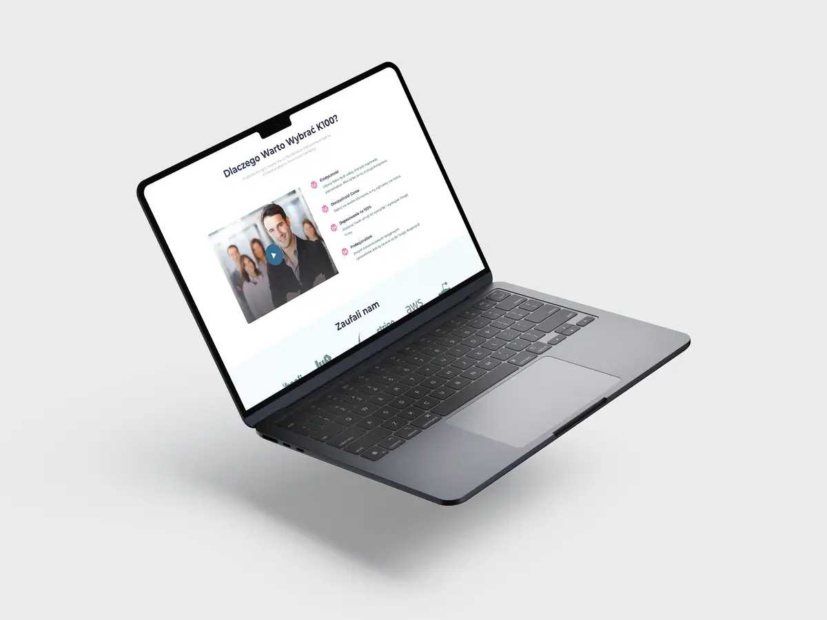 K100: sekcja Dlaczego Warto Wybrać K100? z miniaturą filmu na laptopie