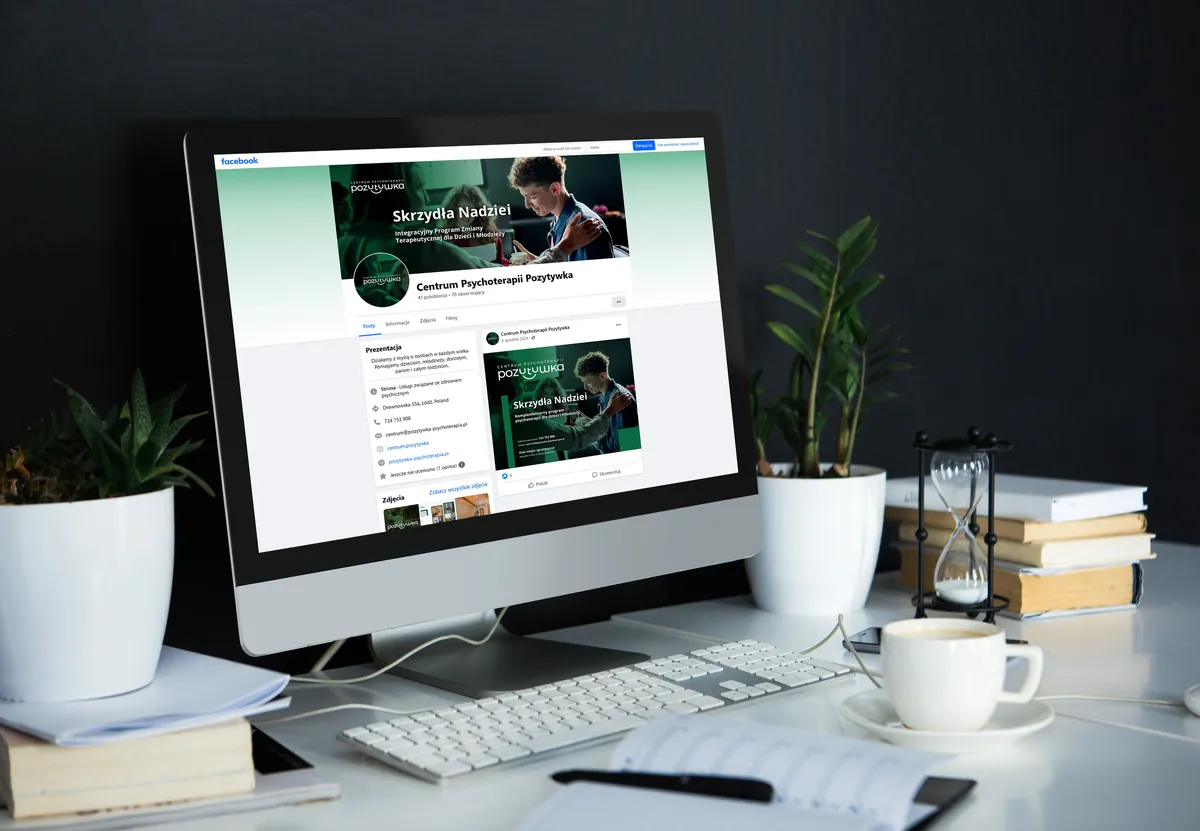 Pozytywka: Facebook profile of the Pozytywka Psychotherapy Center with the Skrzydła Nadziei cover on a monitor at a desk