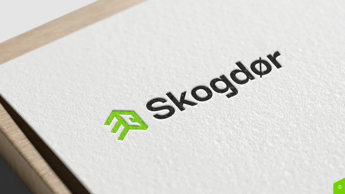 Skogdor: logo with a green brandmark and black lettering embossed on white textured paper